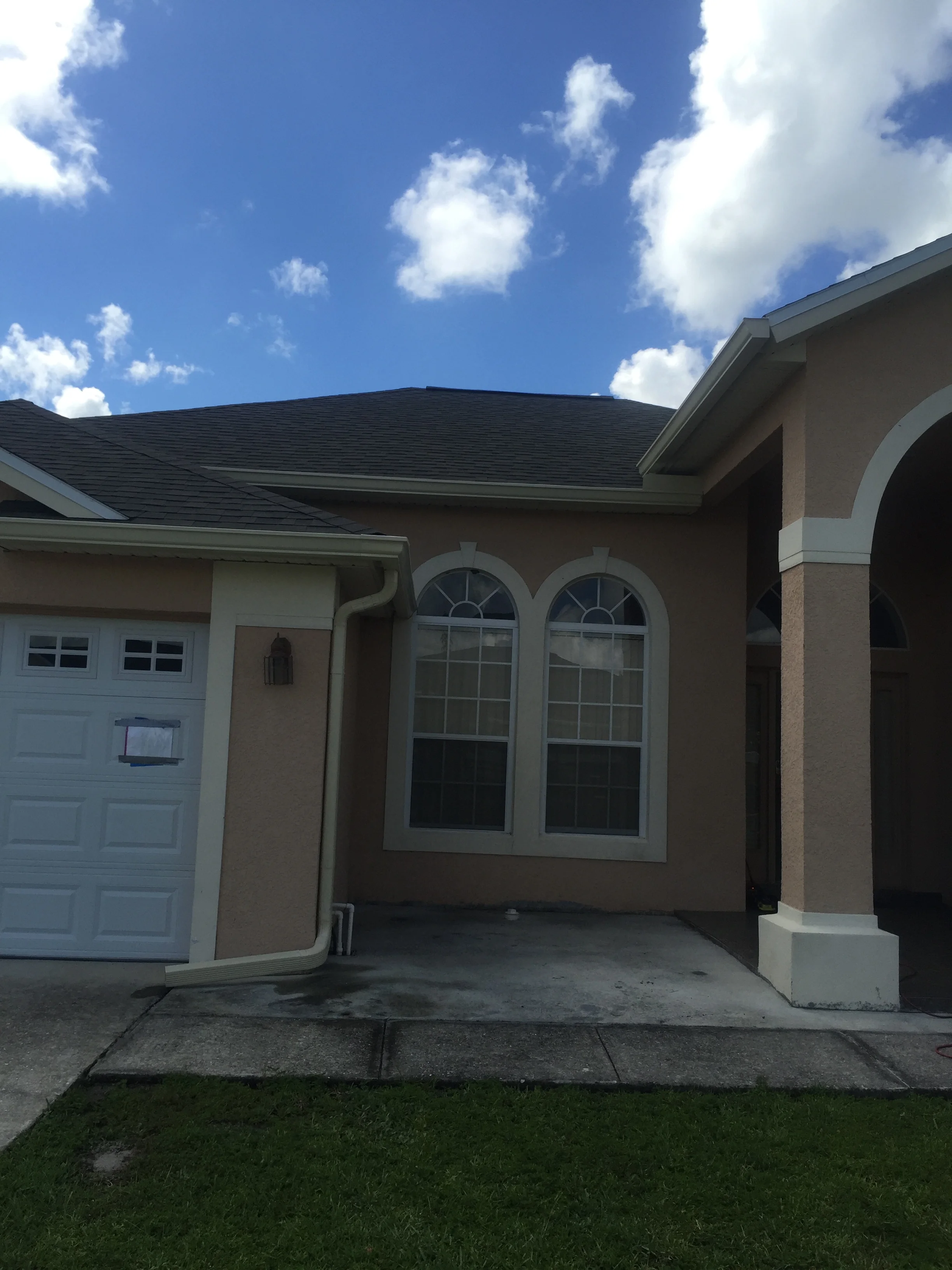 Finished concrete patio with seamed sections and arched architectural entry